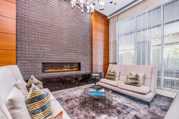 a living room with furniture a fireplace and a table