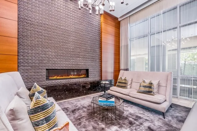 a living room with furniture a fireplace and a table