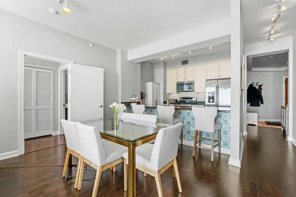 a view of a dining room with furniture and wooden floor