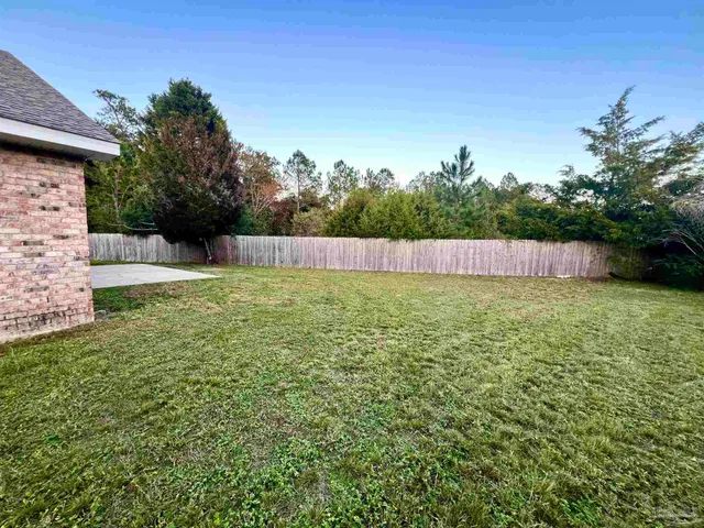 a view of pool with a yard