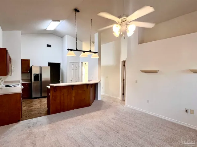 a view of kitchen with cabinets and window
