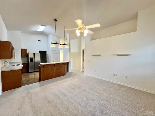 a view of kitchen with refrigerator microwave and wooden floor