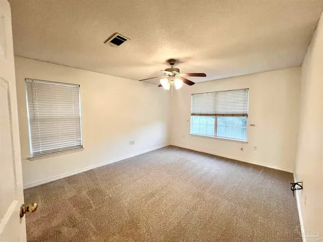 an empty room with a empty space and windows