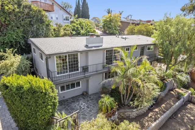 a aerial view of a house with a yard and potted plants