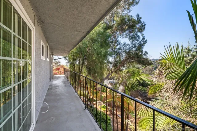 a view of an empty room with a fireplace and a large window