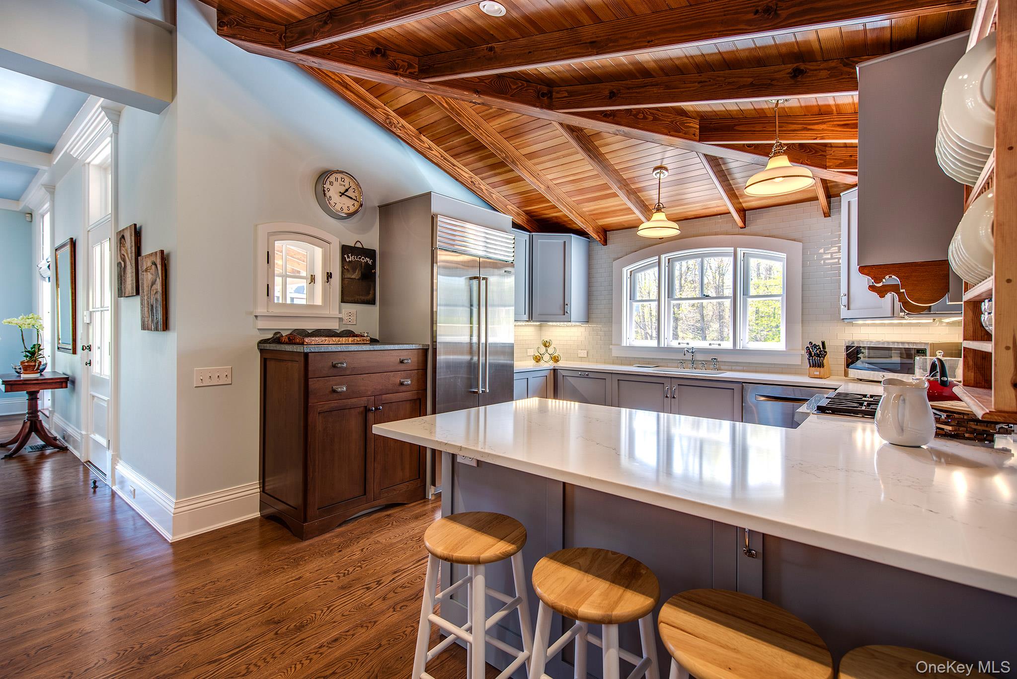106 Old Depot Road Quogue, NY 11959 - Photo 11 of 34 a large kitchen with a table and chairs
