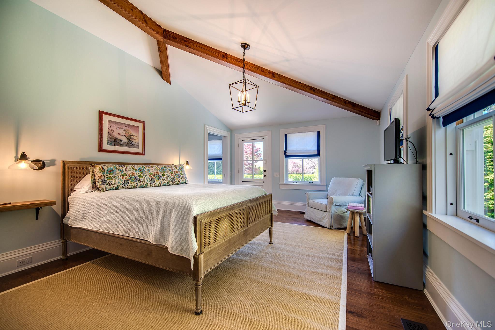 106 Old Depot Road Quogue, NY 11959 - Photo 17 of 34 a spacious bedroom with a bed and wooden floor