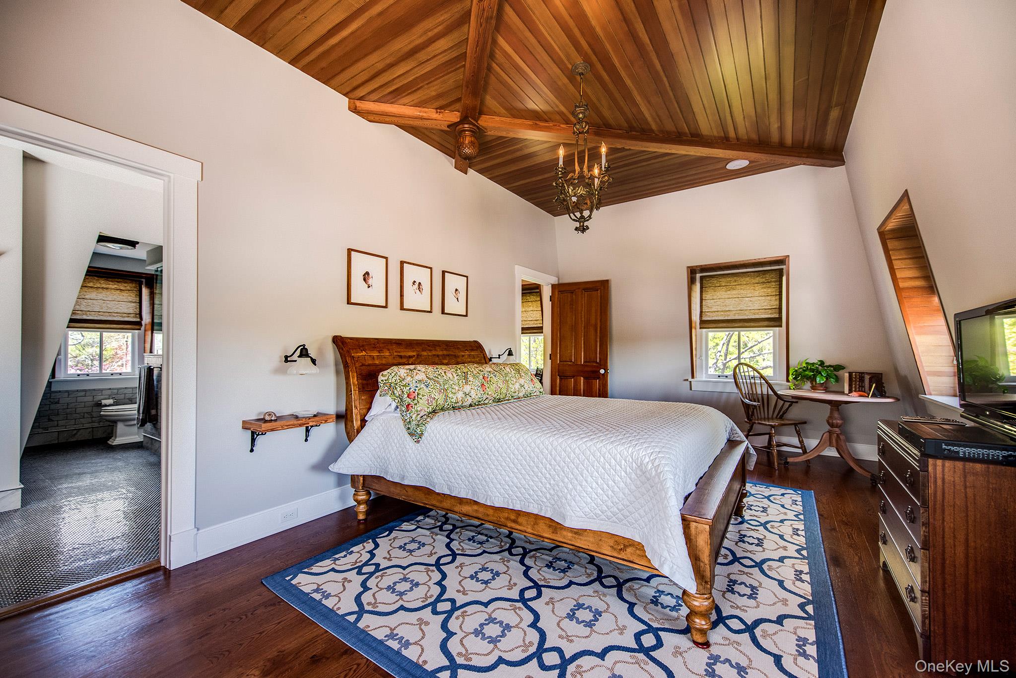 106 Old Depot Road Quogue, NY 11959 - Photo 24 of 34 a bedroom with a bed and wooden floor