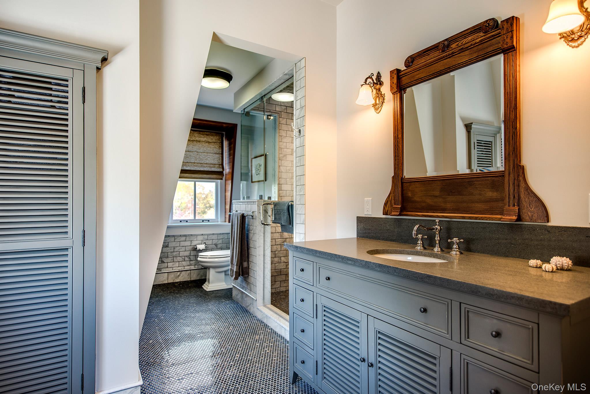 106 Old Depot Road Quogue, NY 11959 - Photo 25 of 34 a en suite bathroom with a sink a mirror and a shower