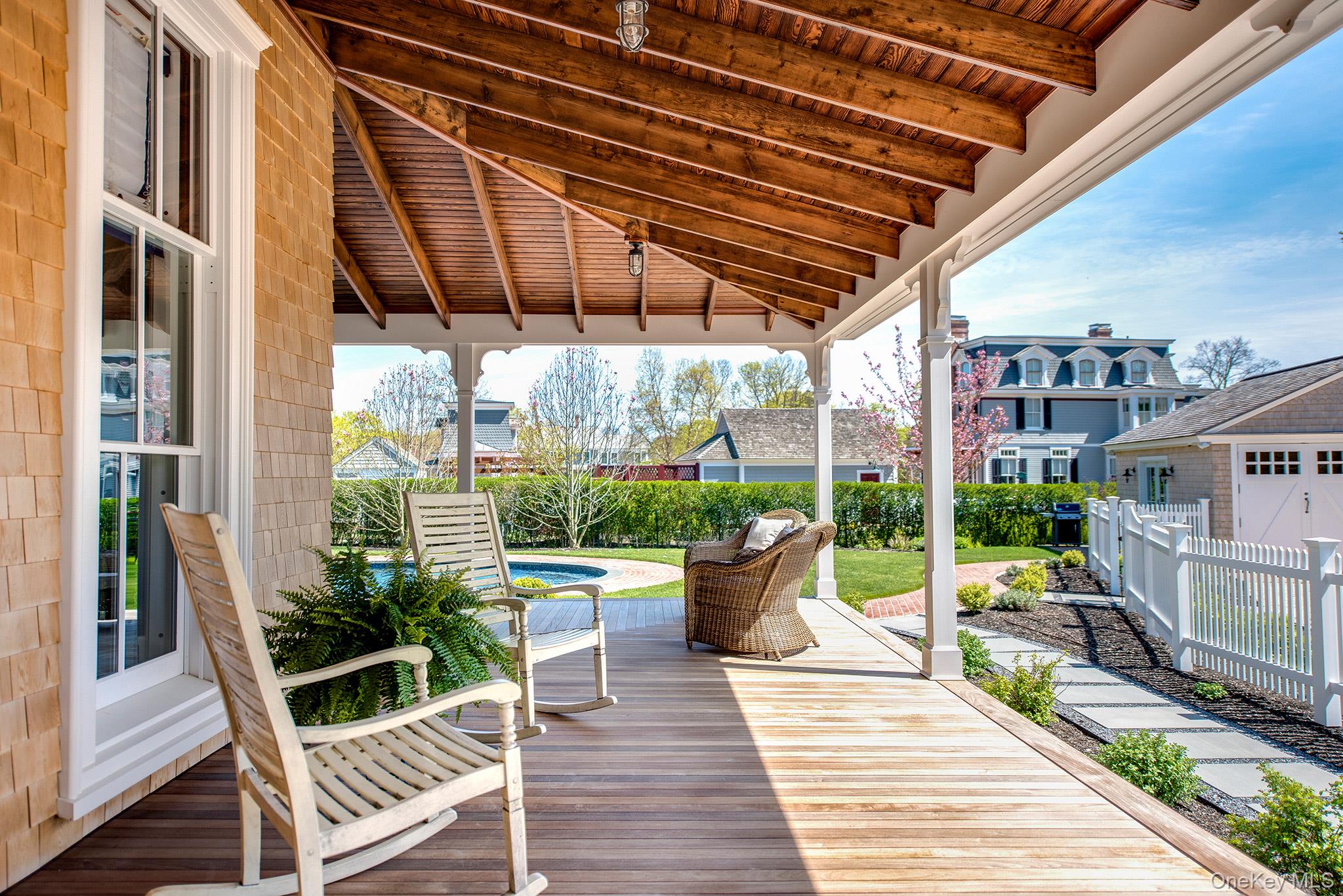106 Old Depot Road Quogue, NY 11959 - Photo 5 of 34 a view of a patio with table and chairs potted plants with wooden floor and plants