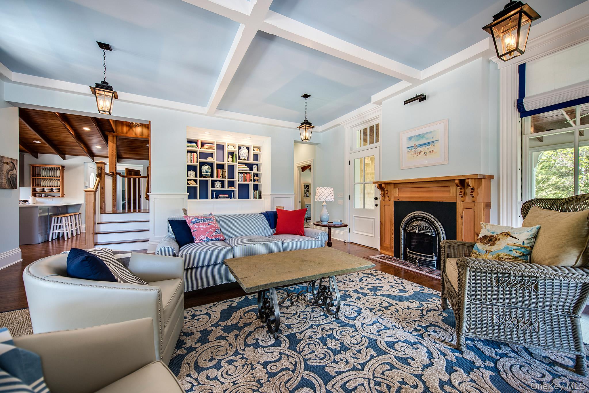 106 Old Depot Road Quogue, NY 11959 - Photo 8 of 34 a living room with furniture a fireplace and a chandelier