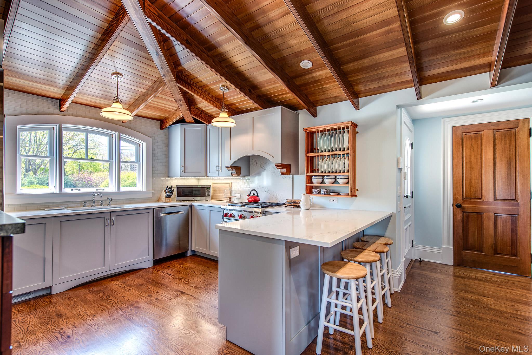 106 Old Depot Road Quogue, NY 11959 - Photo 10 of 34 a large kitchen with a table and chairs