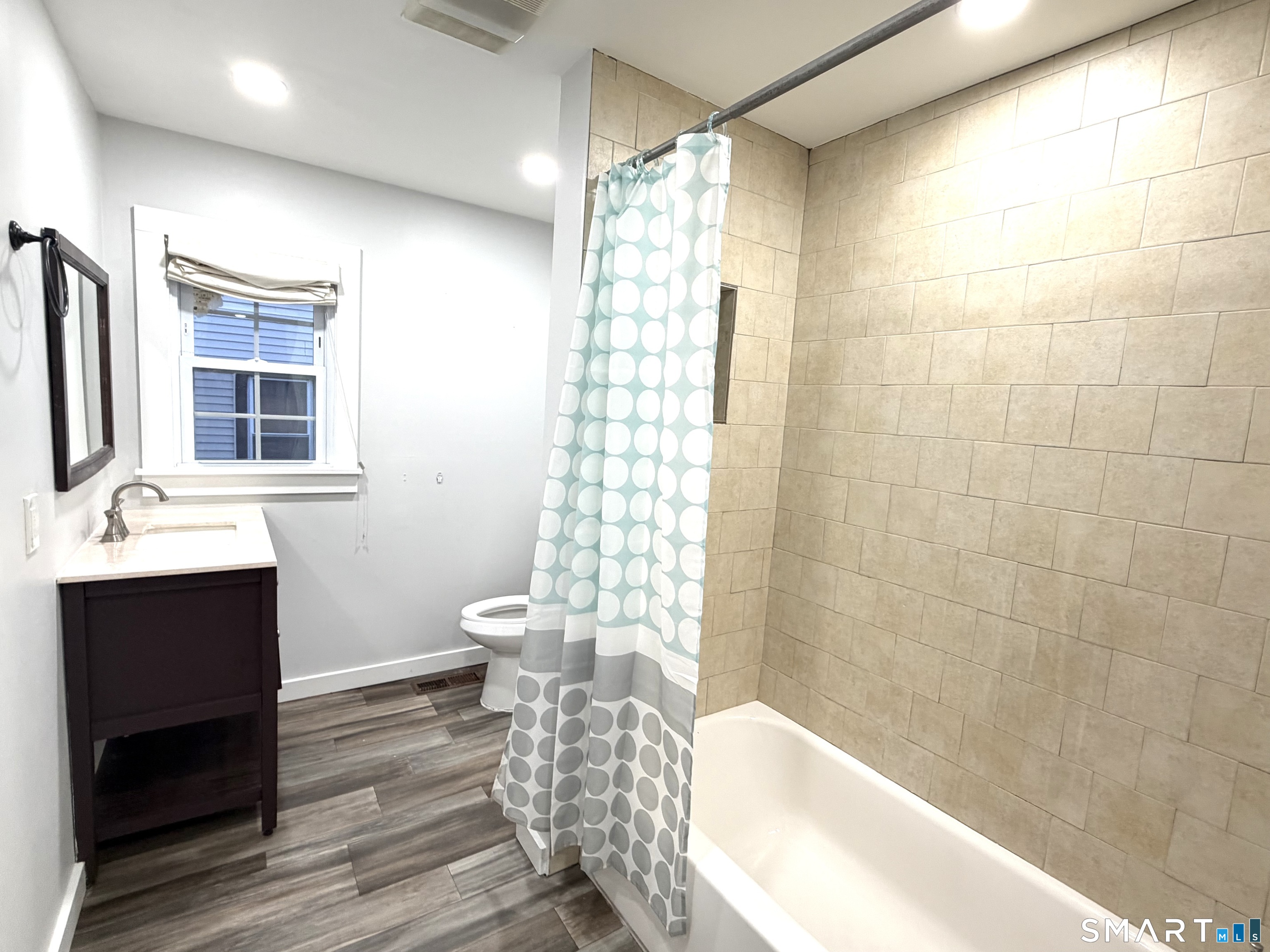 184 Park Street Bridgeport, CT 06608 - Photo 12 of 12 a bathroom with a bathtub shower sink mirror and toilet