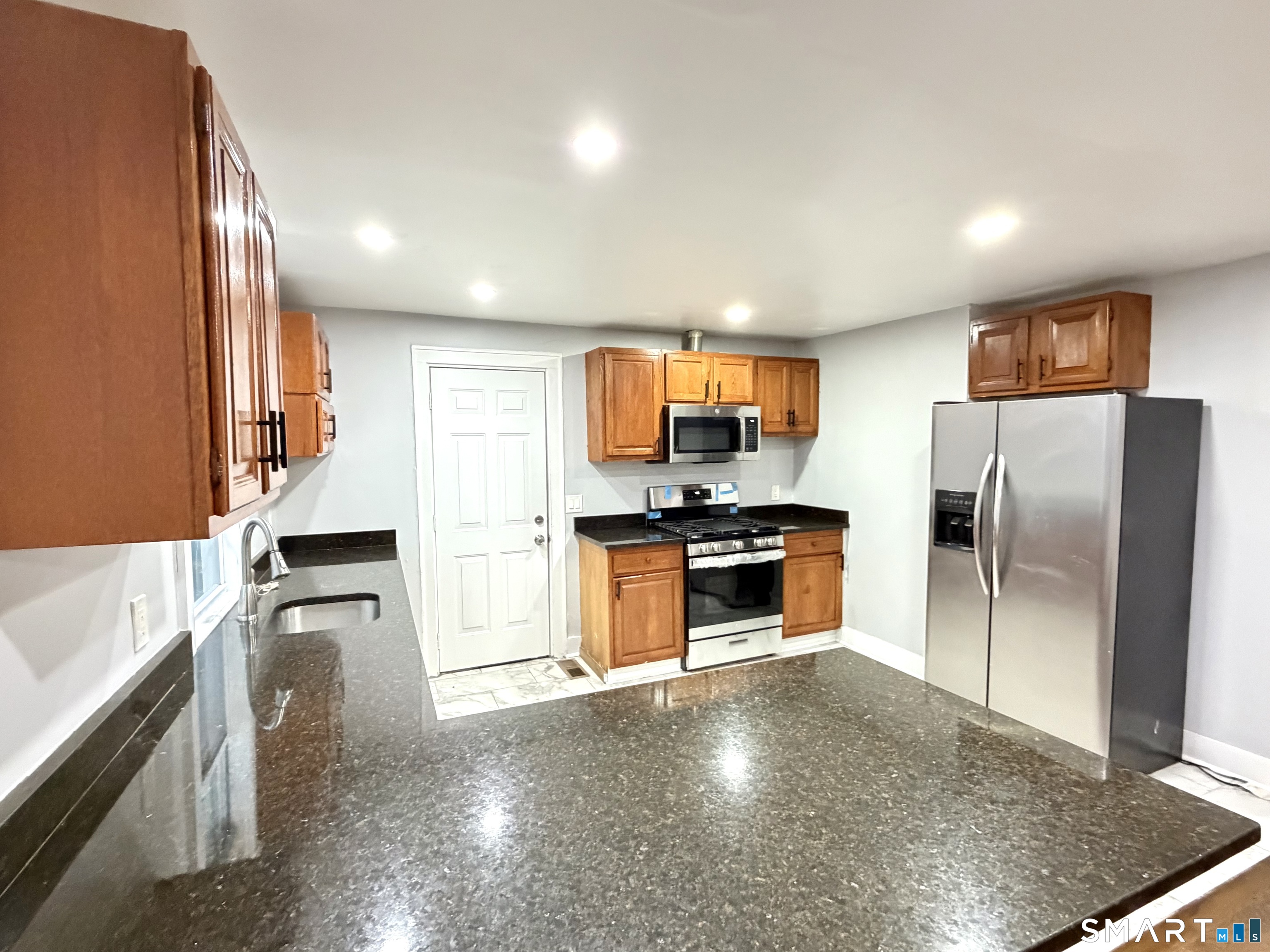 184 Park Street Bridgeport, CT 06608 - Photo 5 of 11 a kitchen with stainless steel appliances a refrigerator sink and stove