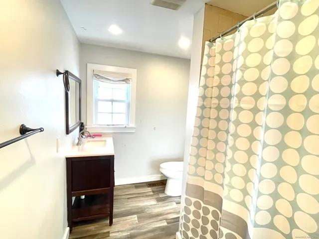 a bathroom with a sink toilet and shower