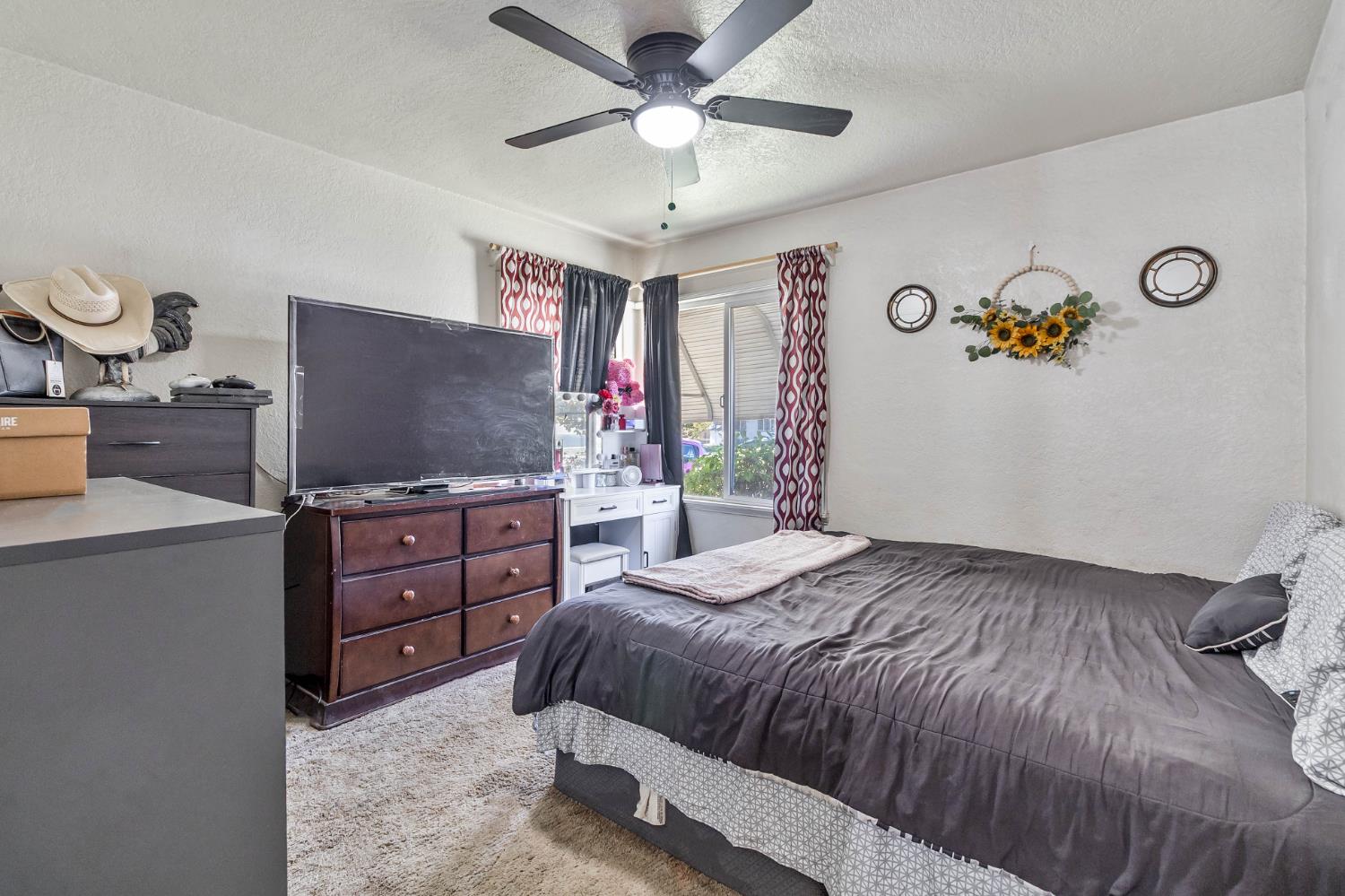 792 Grove Avenue Gustine, CA 95322 - Photo 18 of 32 a bedroom with a bed and a flat screen tv