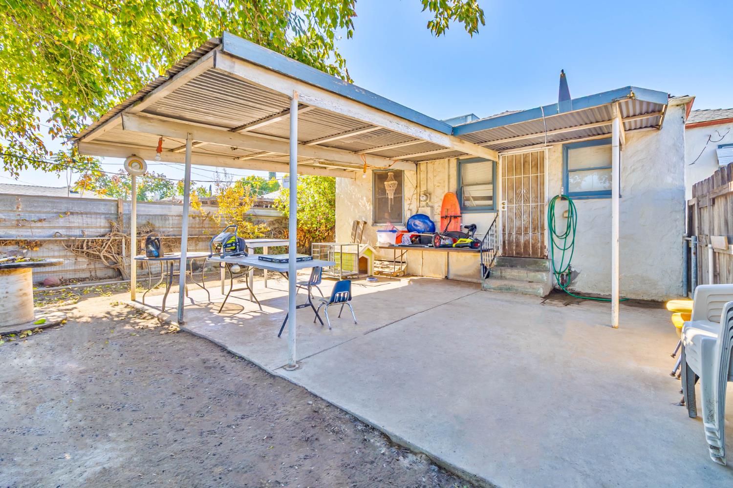 792 Grove Avenue Gustine, CA 95322 - Photo 24 of 32 a view of a chairs and table in the patio and a umbrella