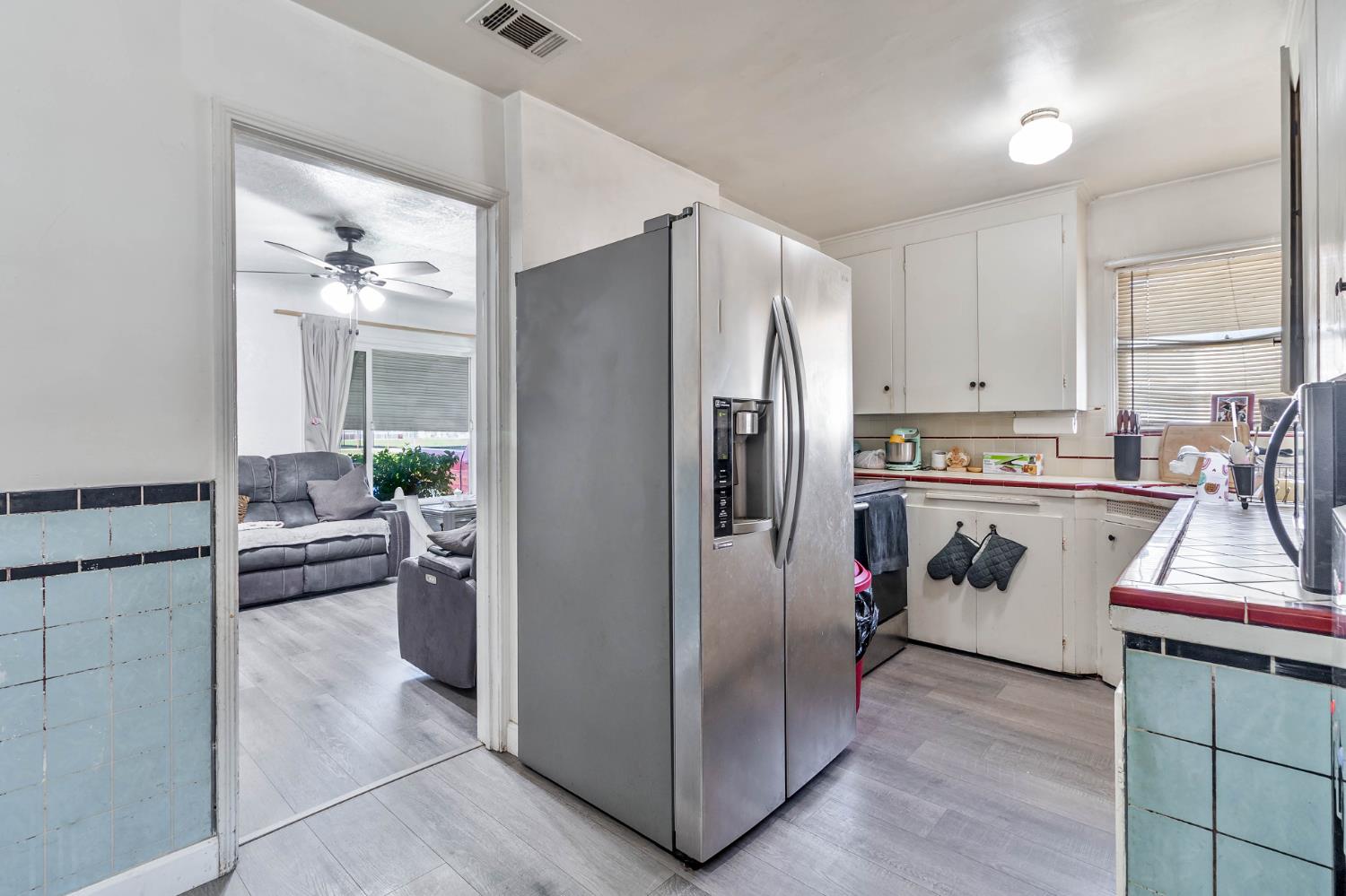 792 Grove Avenue Gustine, CA 95322 - Photo 7 of 32 a kitchen with white cabinets and white appliances