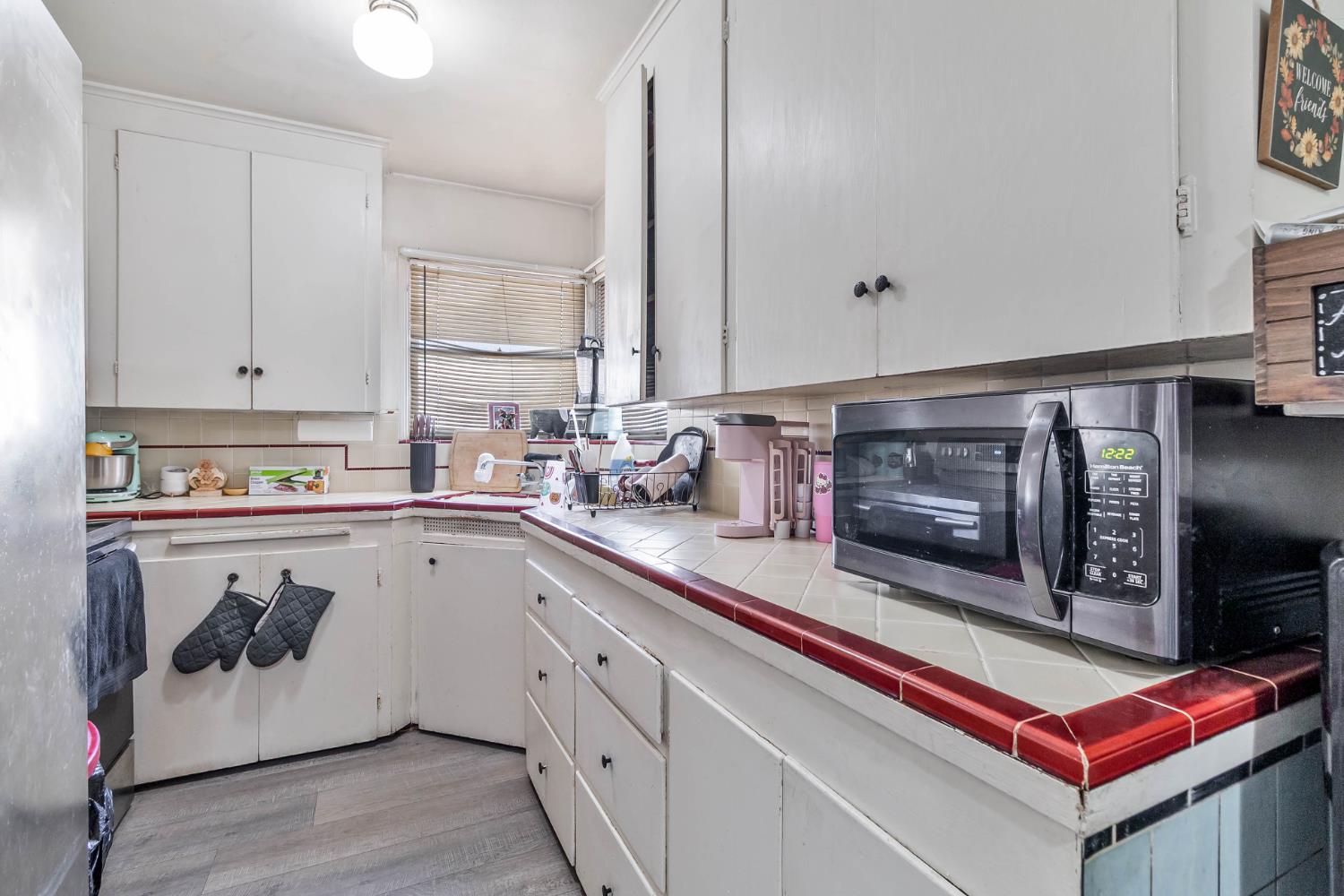 792 Grove Avenue Gustine, CA 95322 - Photo 8 of 32 a kitchen with stainless steel appliances a stove a microwave and cabinets