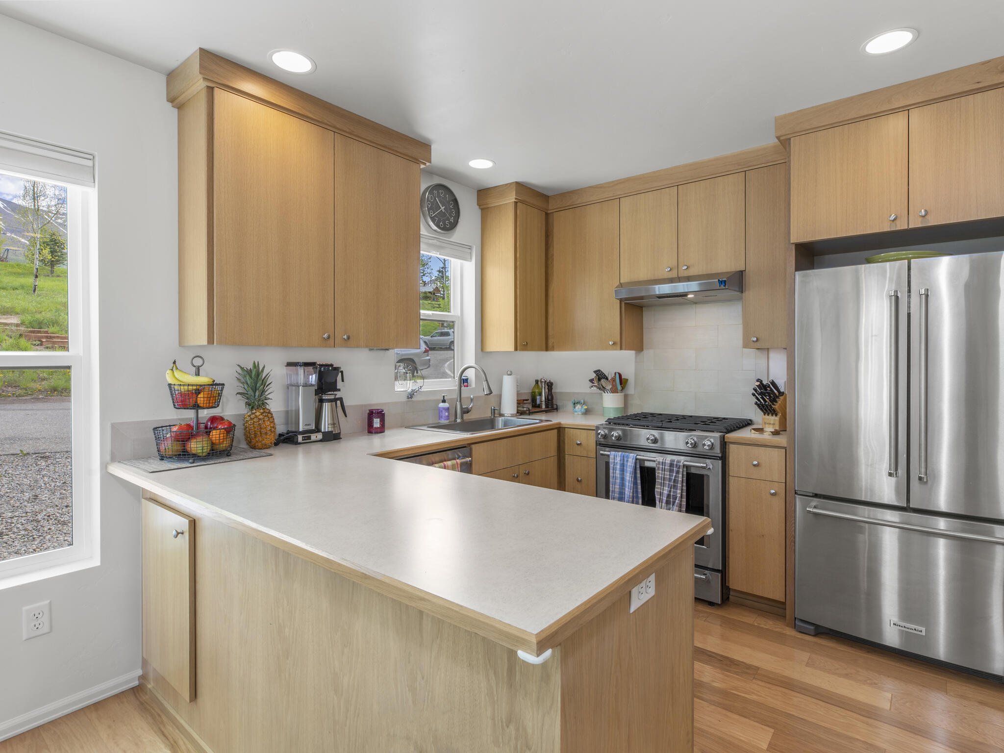 165 Alexander Overlook Telluride, CO 81435 - Photo 5 of 27 a kitchen with stainless steel appliances a sink a stove a refrigerator cabinets and a window