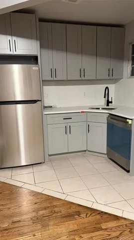 a kitchen with stainless steel appliances a refrigerator sink and cabinets