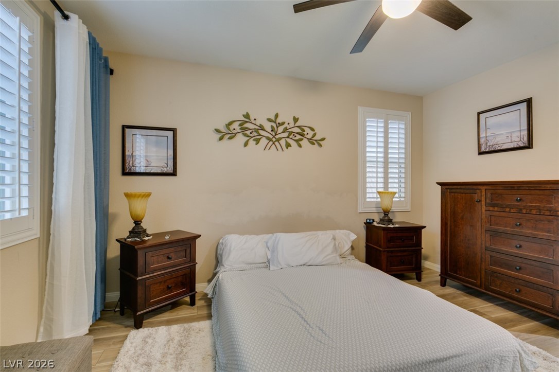 7375 Campbell Ranch Avenue Las Vegas, NV 89179 - Photo 24 of 45 Comfortable bedroom with neutral tones and shuttered windows creates a peaceful retreat.