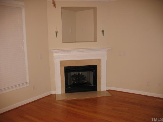 6102 Shandwick Court Raleigh, NC 27609 - Photo 2 of 10 Living room with gas log fireplace and hardwood floors.