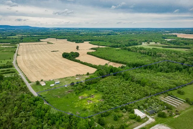an aerial view of a house with a yard and lake view