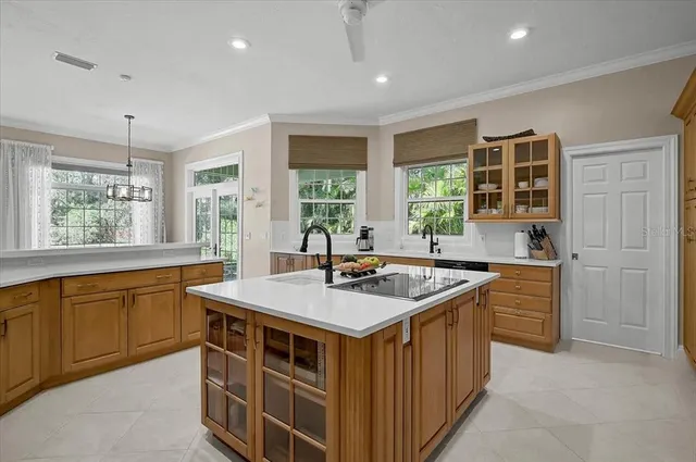 a kitchen that has a sink and a stove in it