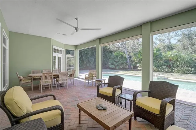 an aerial view of a house with swimming pool and large trees