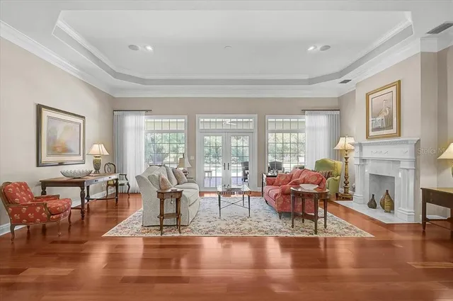 a living room with fireplace furniture and a large window