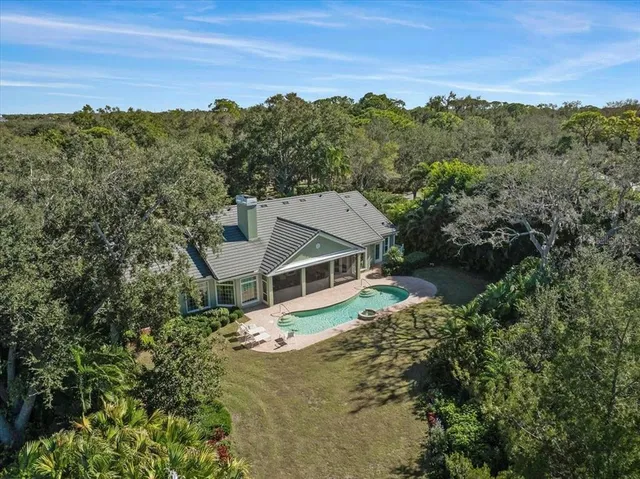 a view of a tennis ground with large trees