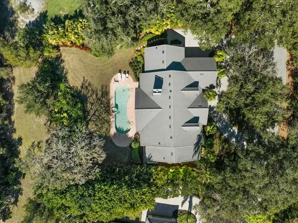 a view of a house with swimming pool and a yard