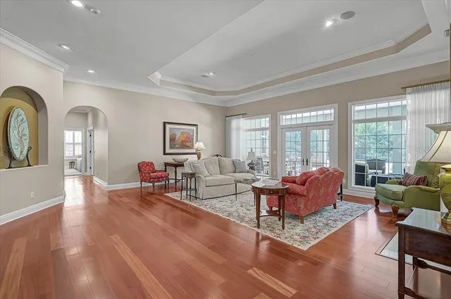 a living room with furniture and floor to ceiling windows