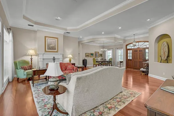 a living room with furniture and wooden floor