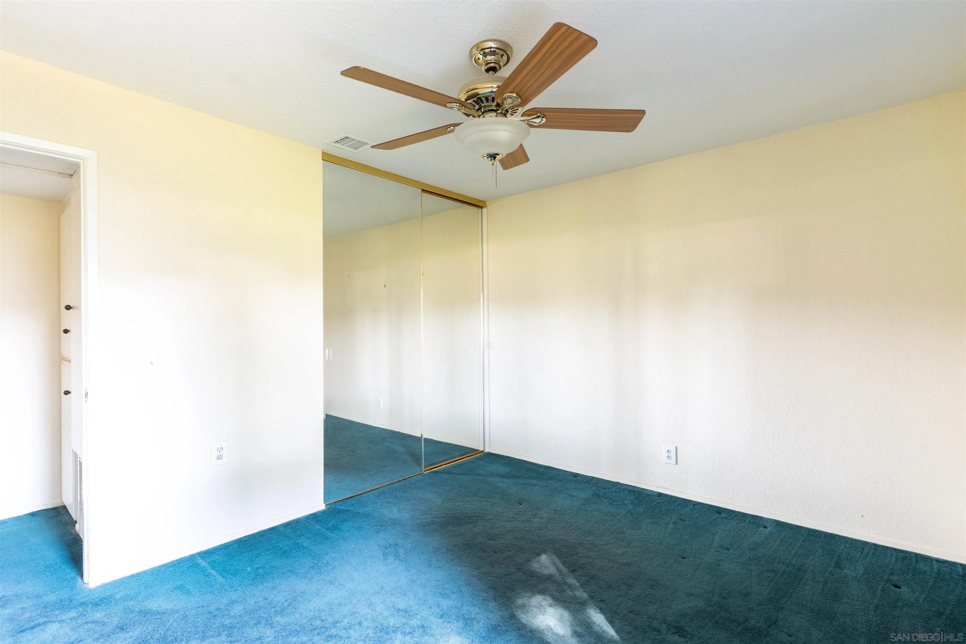 2825 Irving Street Riverside, CA 92504 - Photo 12 of 31 an empty room with a ceiling fan and a window