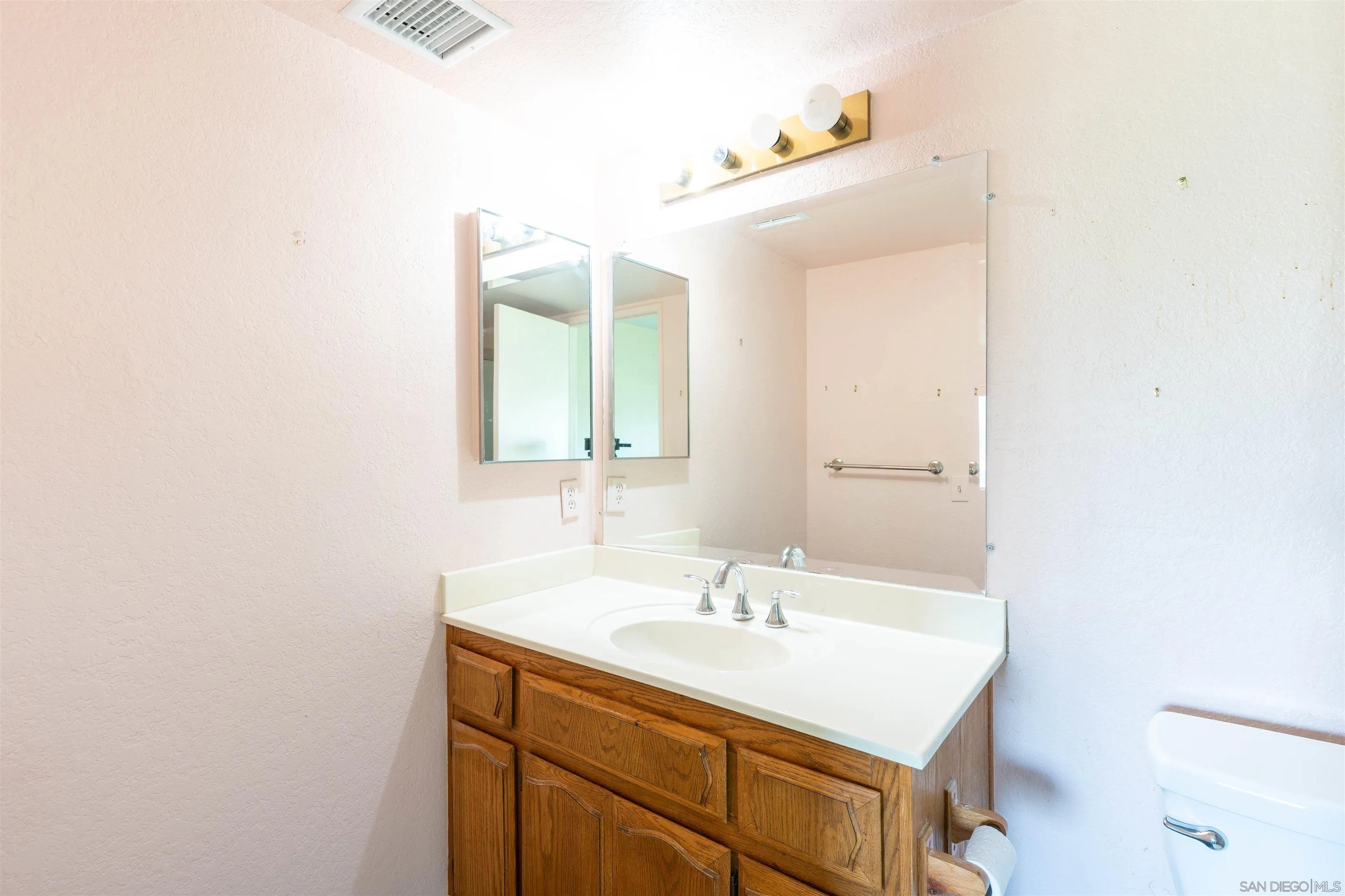 2825 Irving Street Riverside, CA 92504 - Photo 18 of 31 a bathroom with a sink and a mirror