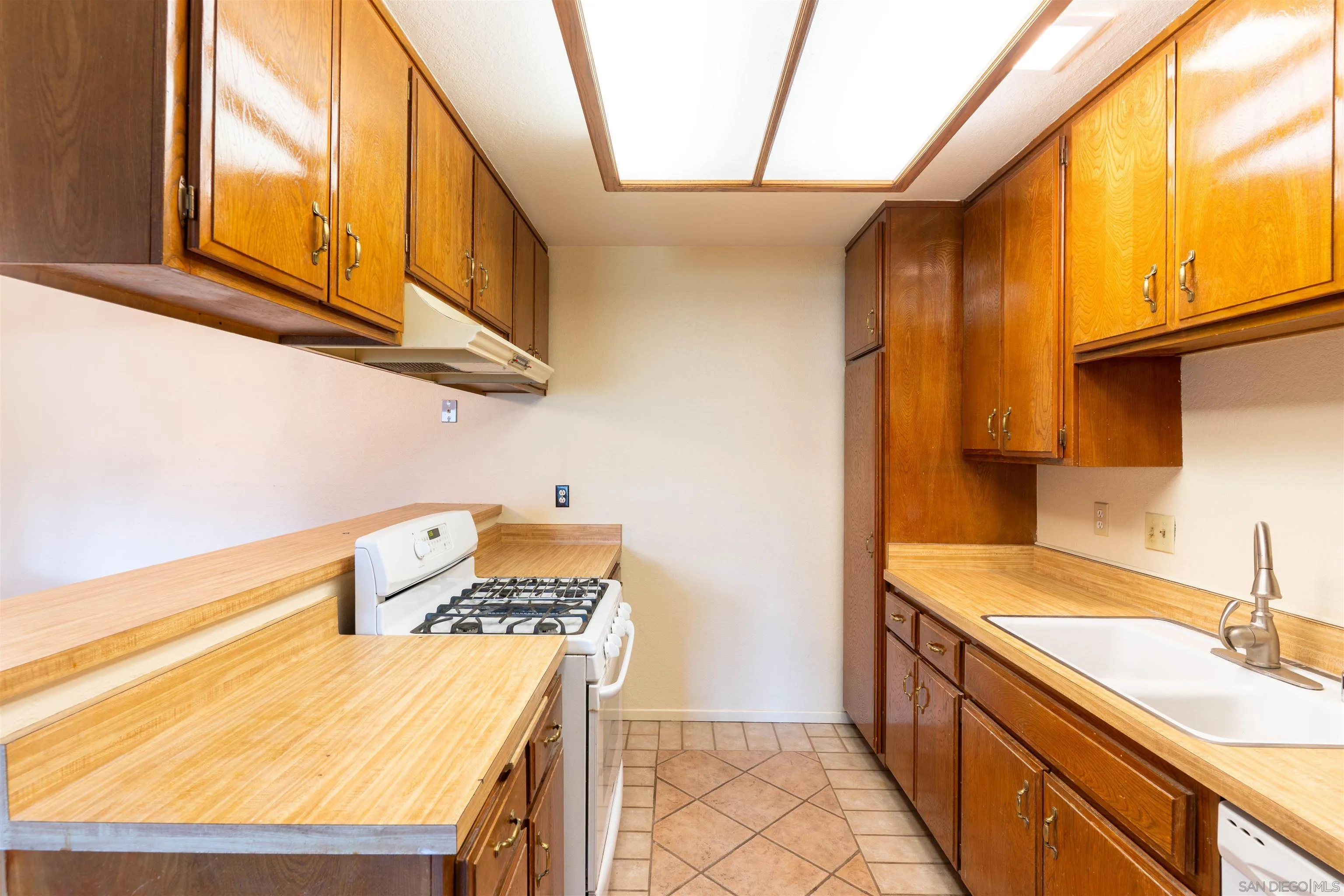 2825 Irving Street Riverside, CA 92504 - Photo 9 of 31 a kitchen with a sink a stove and cabinets