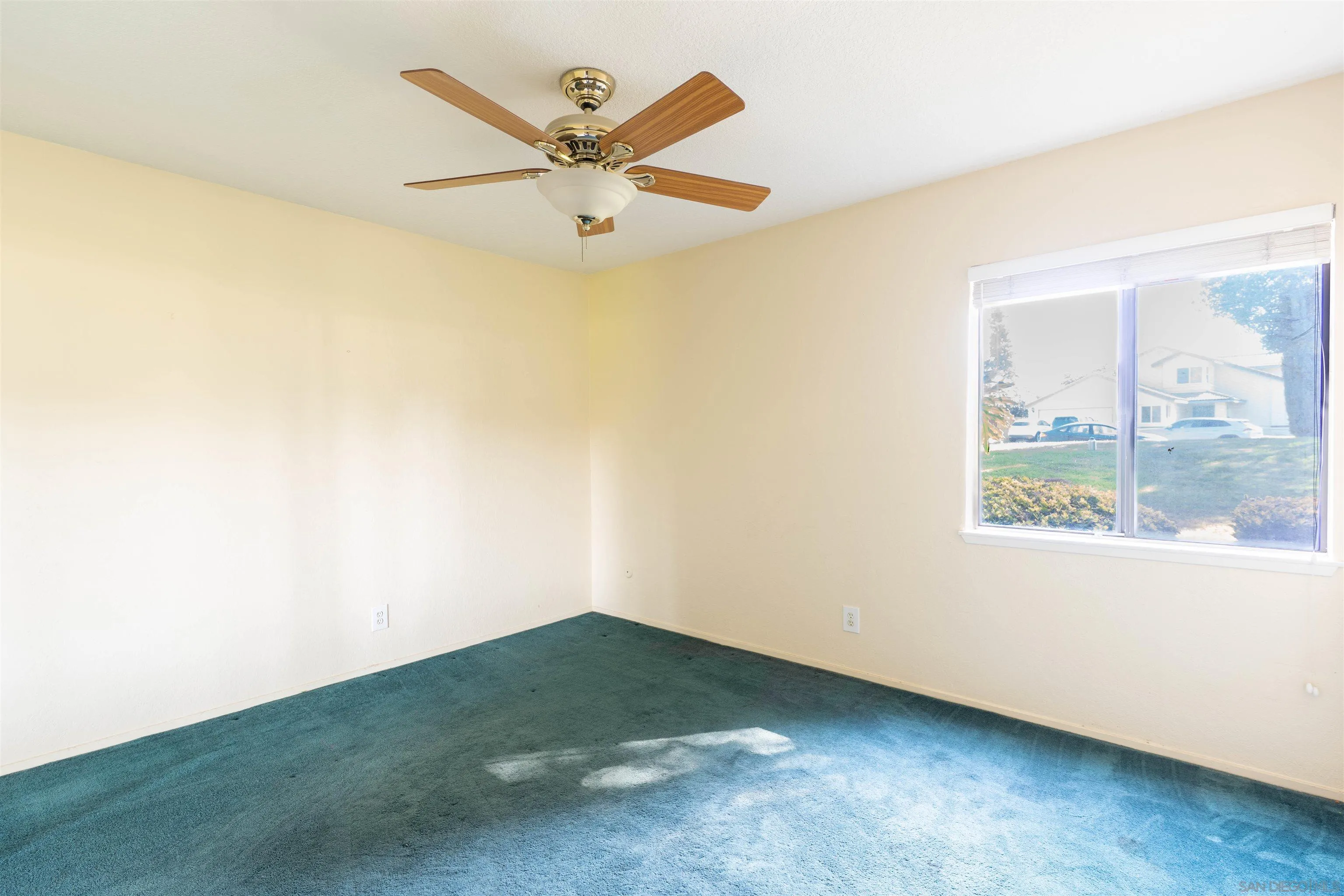 2825 Irving Street Riverside, CA 92504 - Photo 10 of 31 an empty room with a window and a ceiling fan