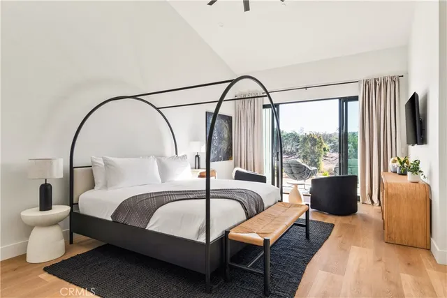 a bedroom with a bed and a large window