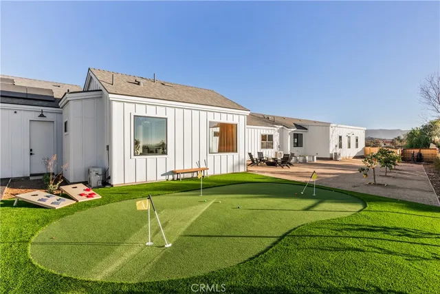 a swimming pool with outdoor seating and yard