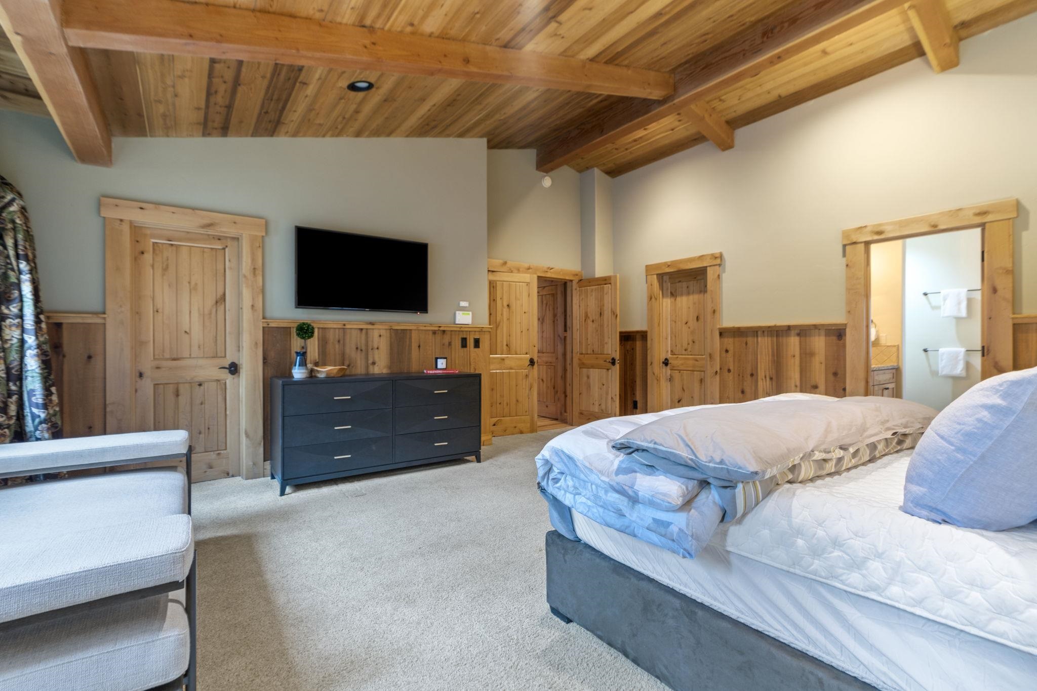 735 Cascade Circle Homewood, CA 96141 - Photo 13 of 21 a living room with a bed and a flat screen television