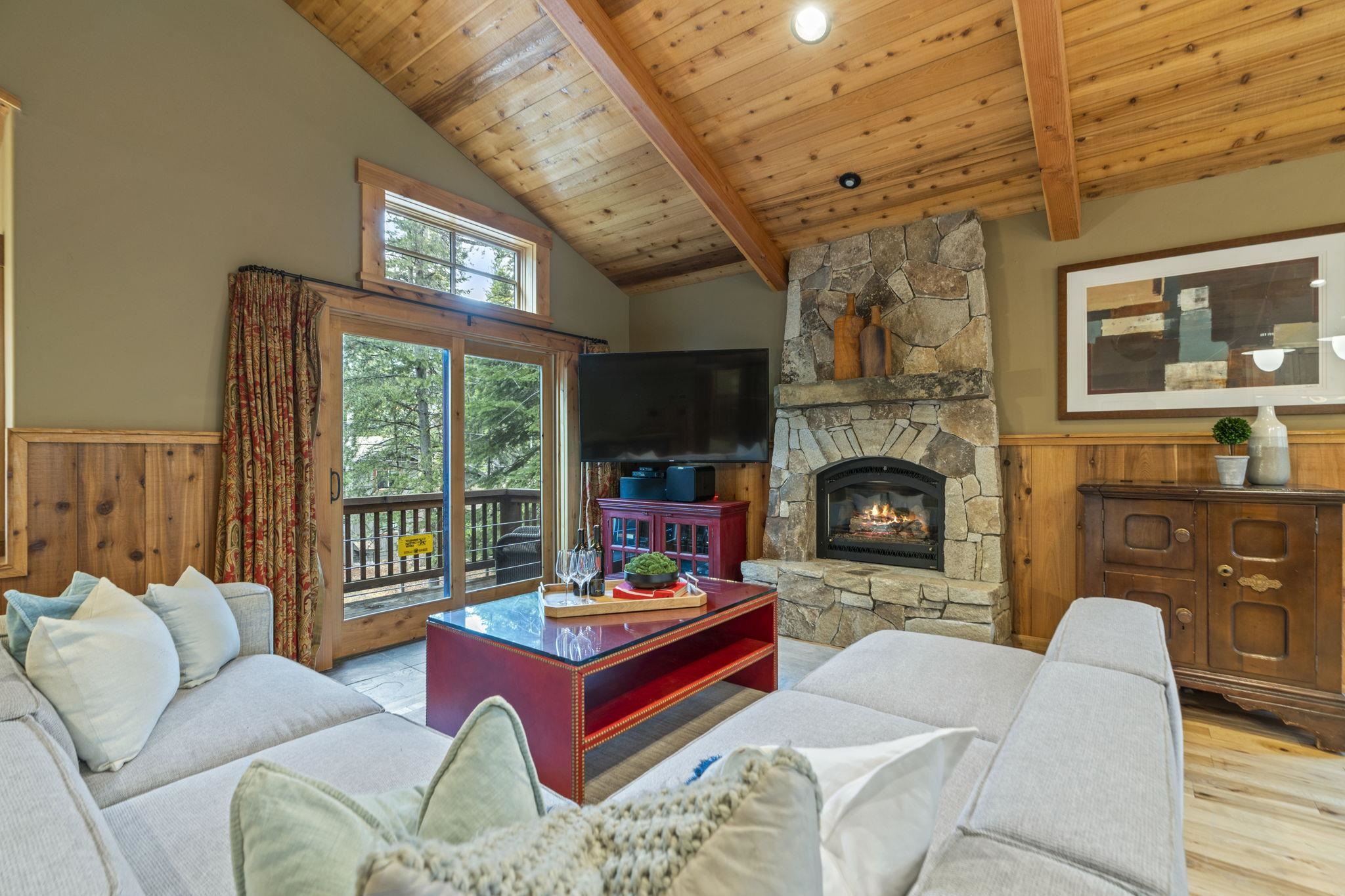 735 Cascade Circle Homewood, CA 96141 - Photo 5 of 21 a living room with furniture a fireplace and a large window