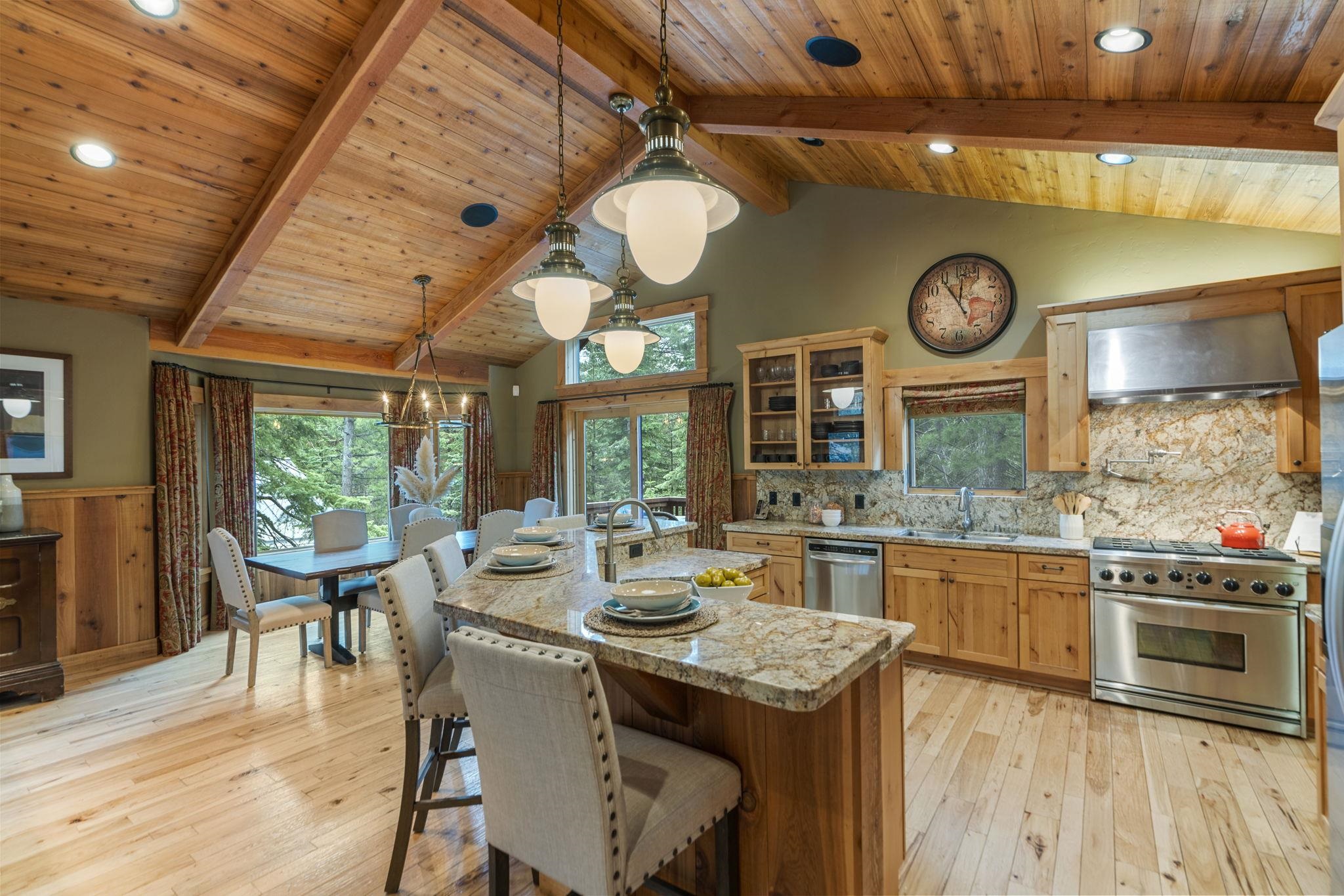 735 Cascade Circle Homewood, CA 96141 - Photo 8 of 21 a kitchen with a stove and a clock on the wall next to a window