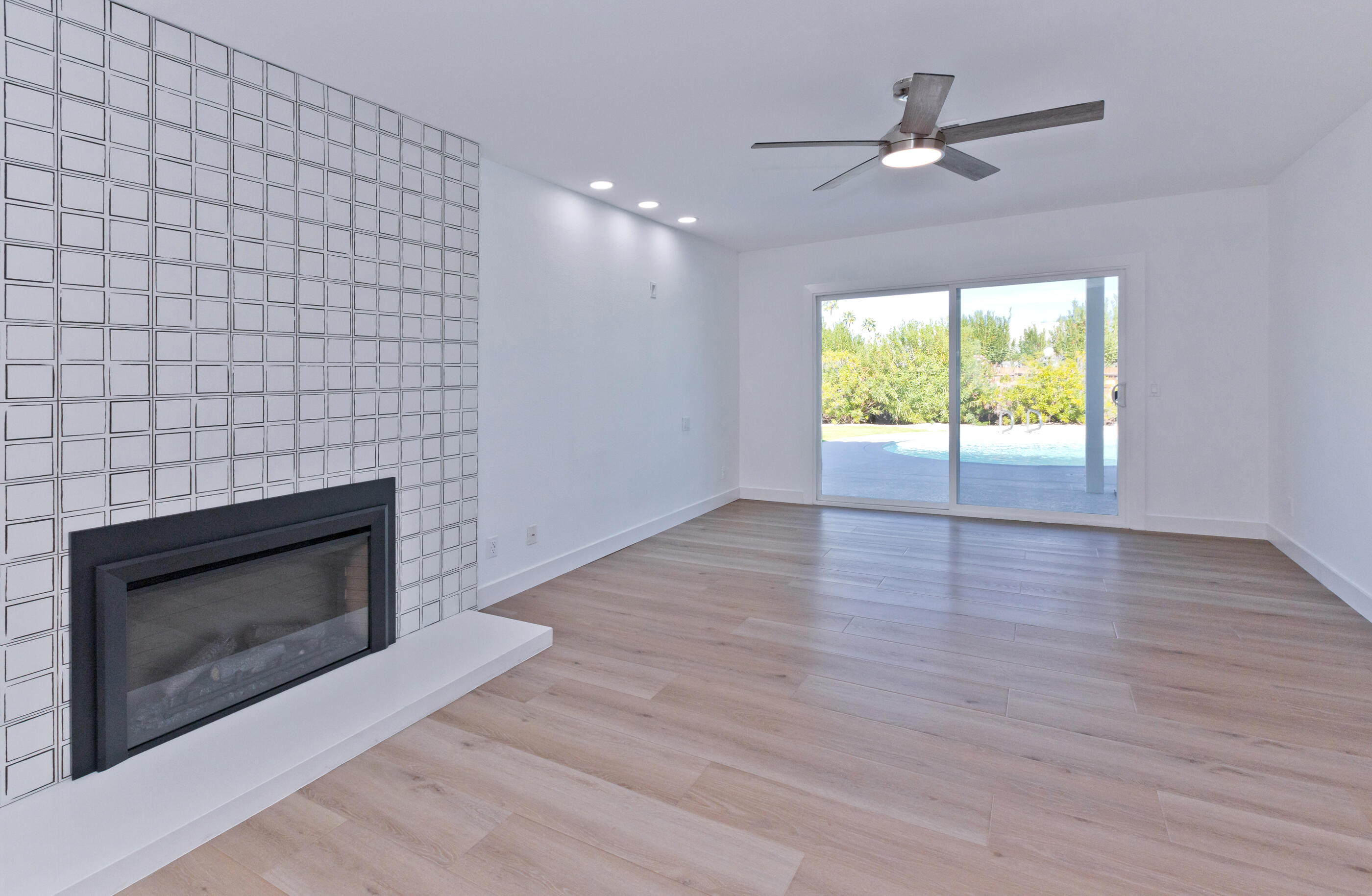 72920 Somera Road Palm Desert, CA 92260 - Photo 18 of 49 a view of an empty room with wooden floor and a fireplace