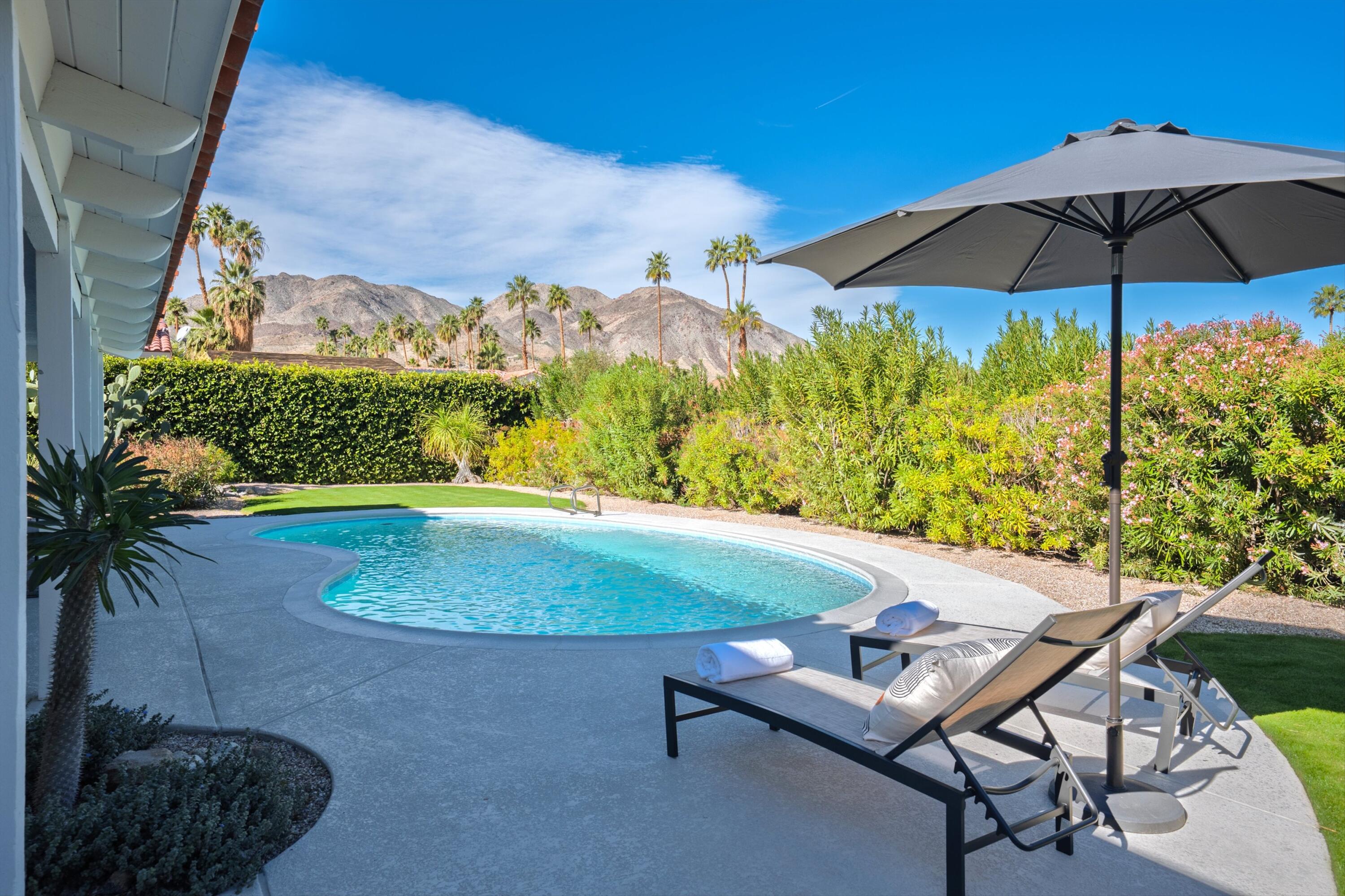 72920 Somera Road Palm Desert, CA 92260 - Photo 2 of 49 a view of a swimming pool in a backyard