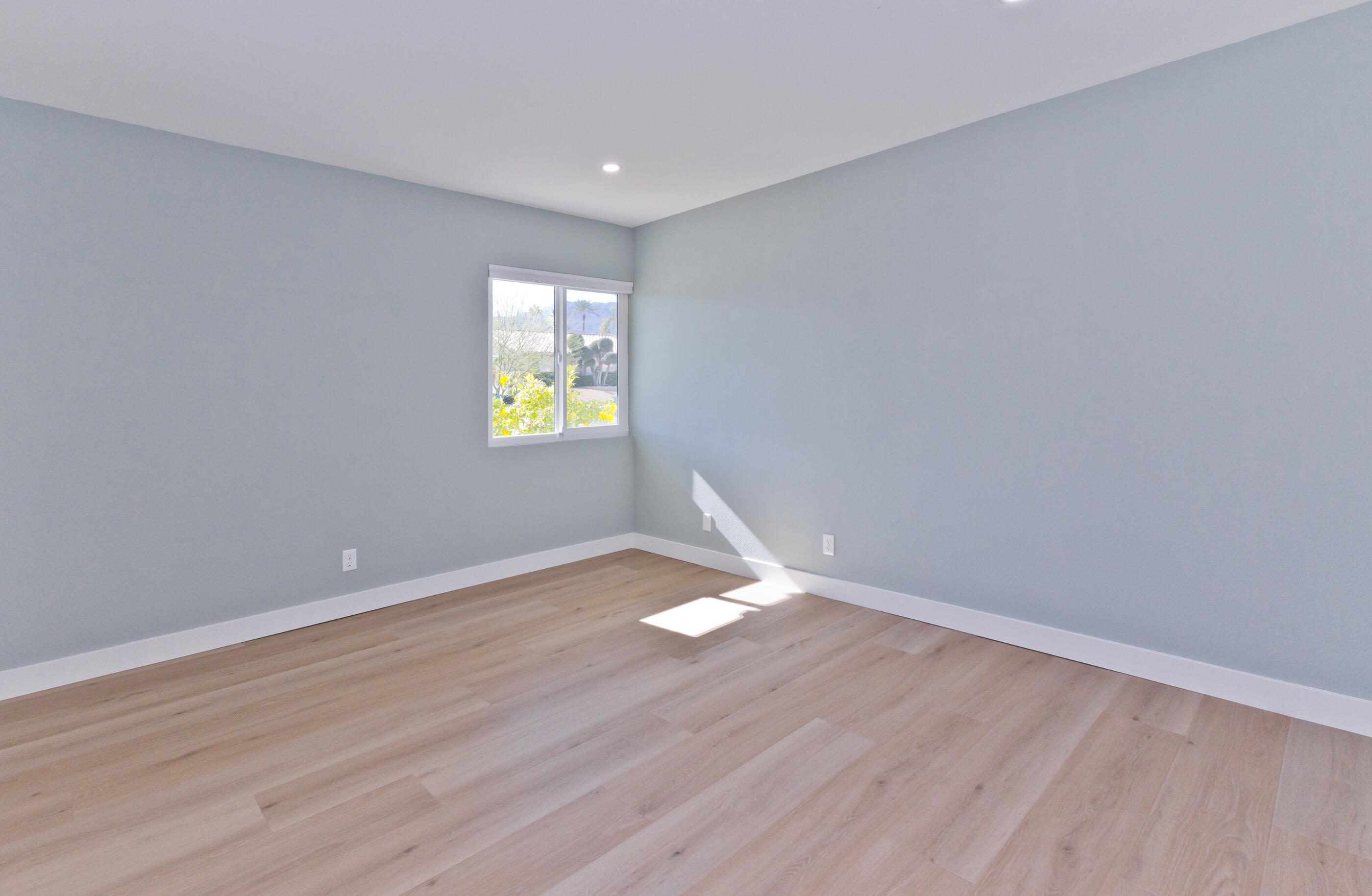 72920 Somera Road Palm Desert, CA 92260 - Photo 22 of 49 wooden floor in an empty room with a window