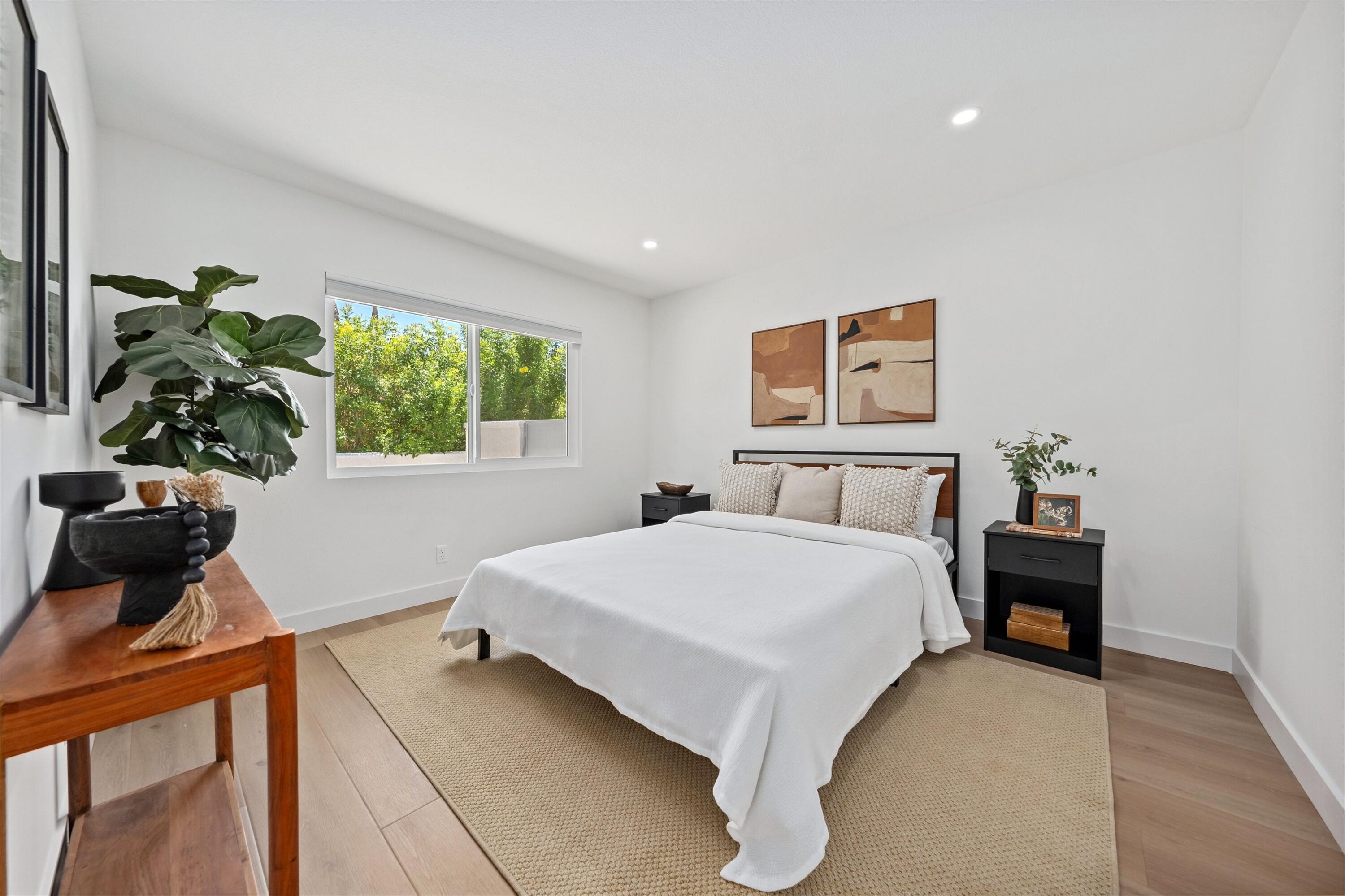 72920 Somera Road Palm Desert, CA 92260 - Photo 23 of 49 a bedroom with a bed table and a window