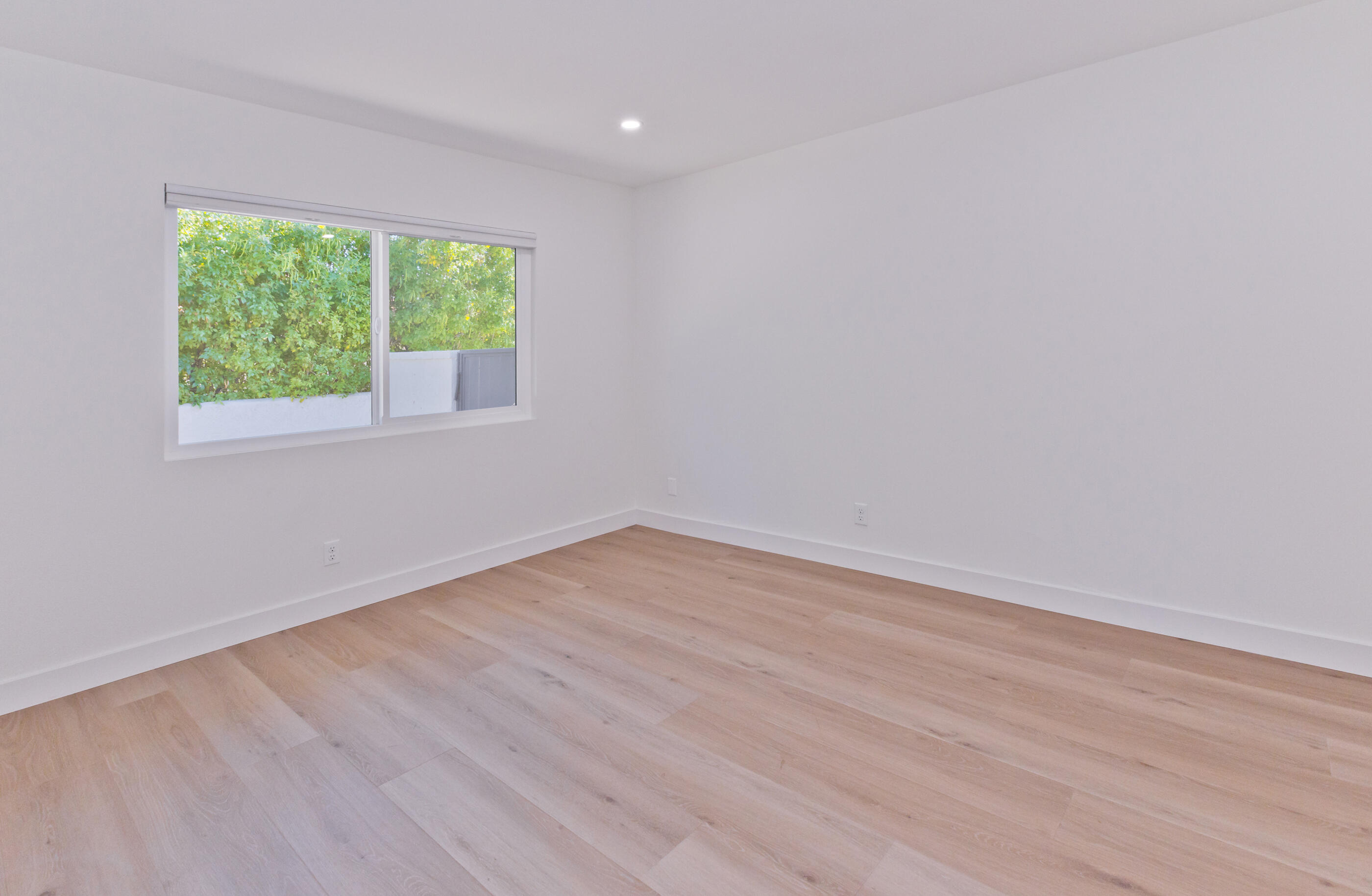 72920 Somera Road Palm Desert, CA 92260 - Photo 24 of 49 a view of an empty room with wooden floor and a window