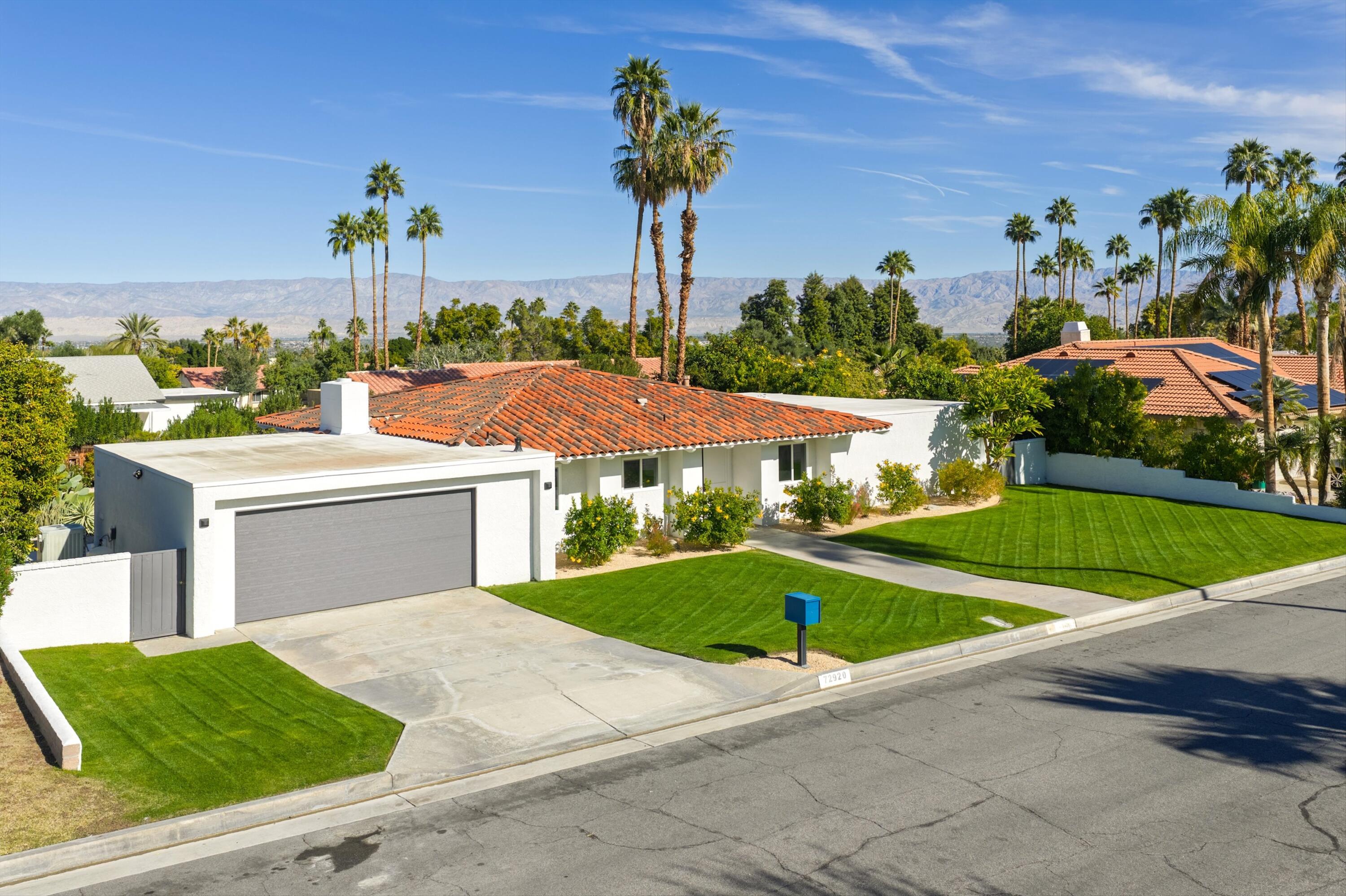 72920 Somera Road Palm Desert, CA 92260 - Photo 30 of 49 a front view of a house with garden